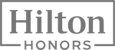 This image shows the "Hilton Honors" logo, featuring the brand name in a stylized design bordered by a rectangular frame.